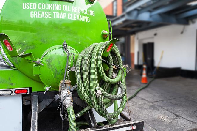 heavy-duty vacuum truck pumping out a grease trap in Auburn